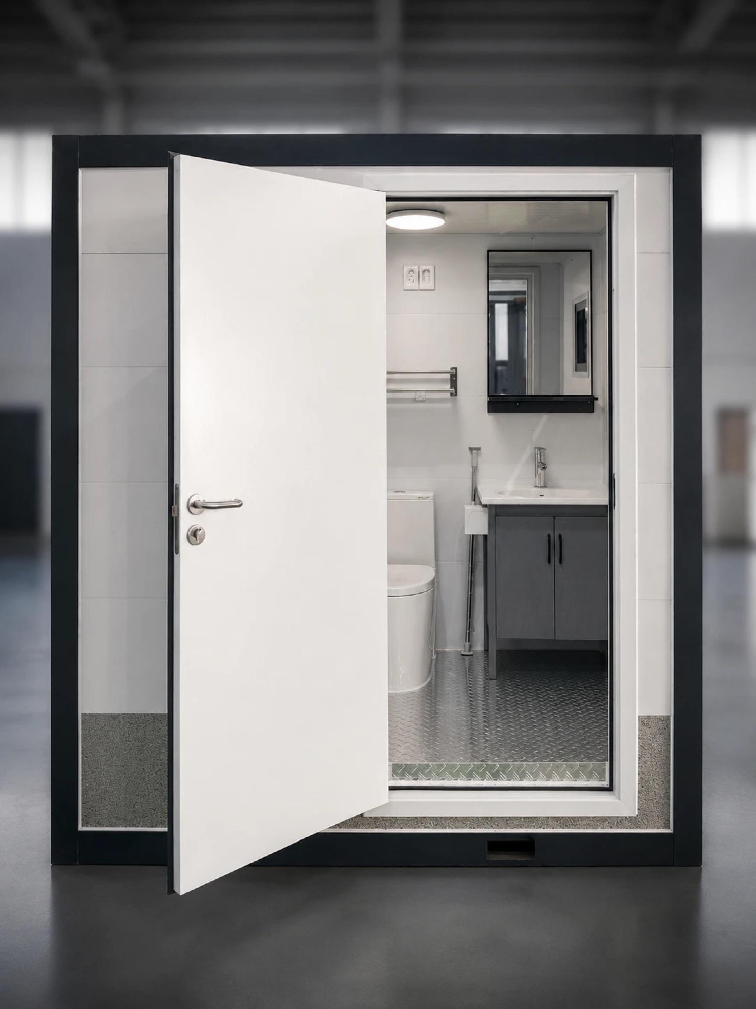 SleekBath bathroom pod with the door open, showing the toilet, vanity and mirror inside